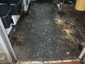 Old stained commercial kitchen floor