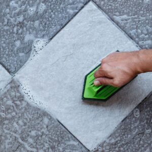 a person using soap and water on a tile