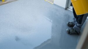 epoxy flooring flakes being added to floor