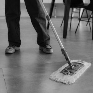 Wiping a floor with a broom